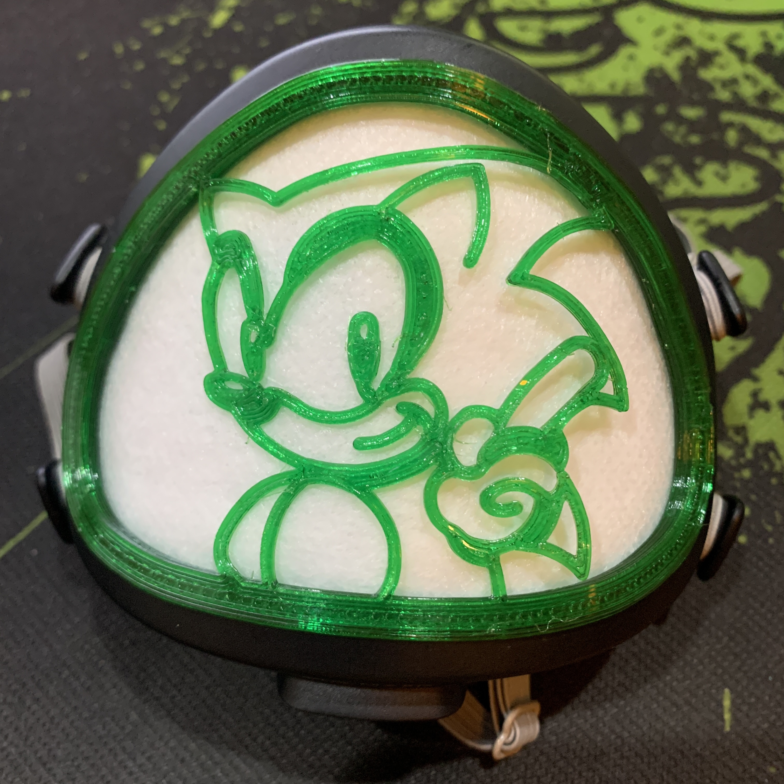 A Flo Mask, with a 3D printed outline of Sonic the Hedgehog slotted into it